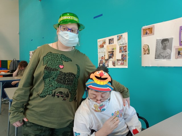 Sam and Lizzy wearing funny hats on hat day. St Patricks day hat and a sesame street hat.