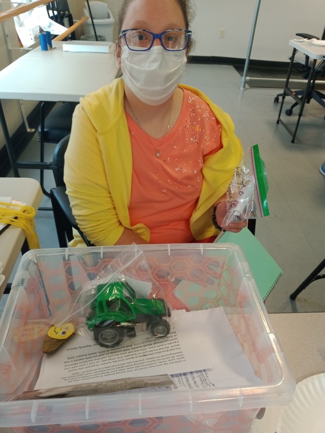 Lizzy Putting Items in Her Time Capsule