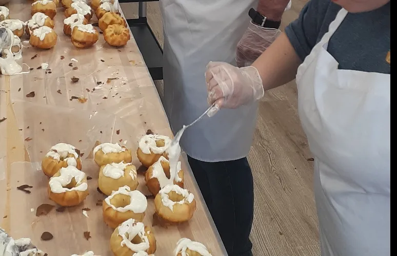 A baker ices mini bundt cakes