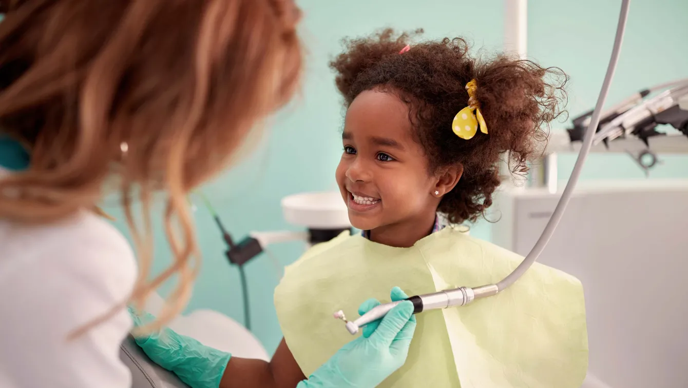 Little girl smiling at dental office.