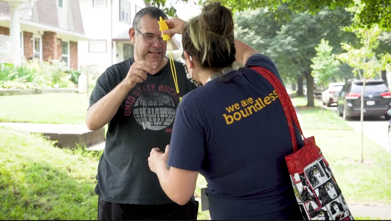 A Boundless DSP handing a bubble wand to a client