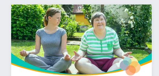 Two women sitting next to each other meditating.