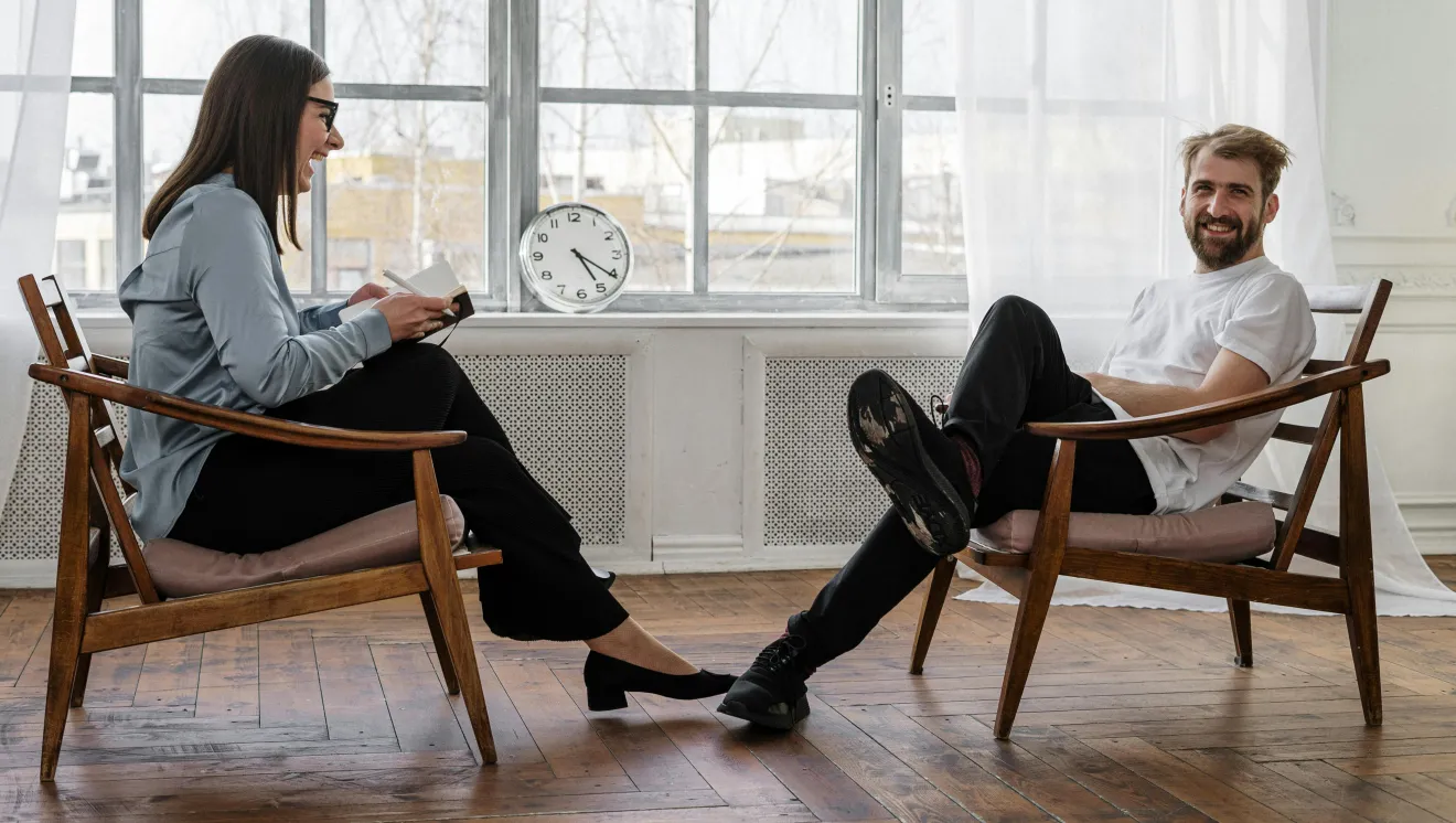 two people sit across from each other in a counseling session